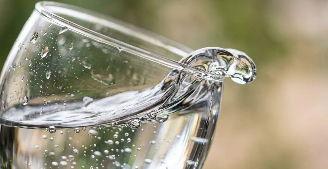 Macro detailed view of clear liquid demonstrating fluid physics and gravitational flow principles