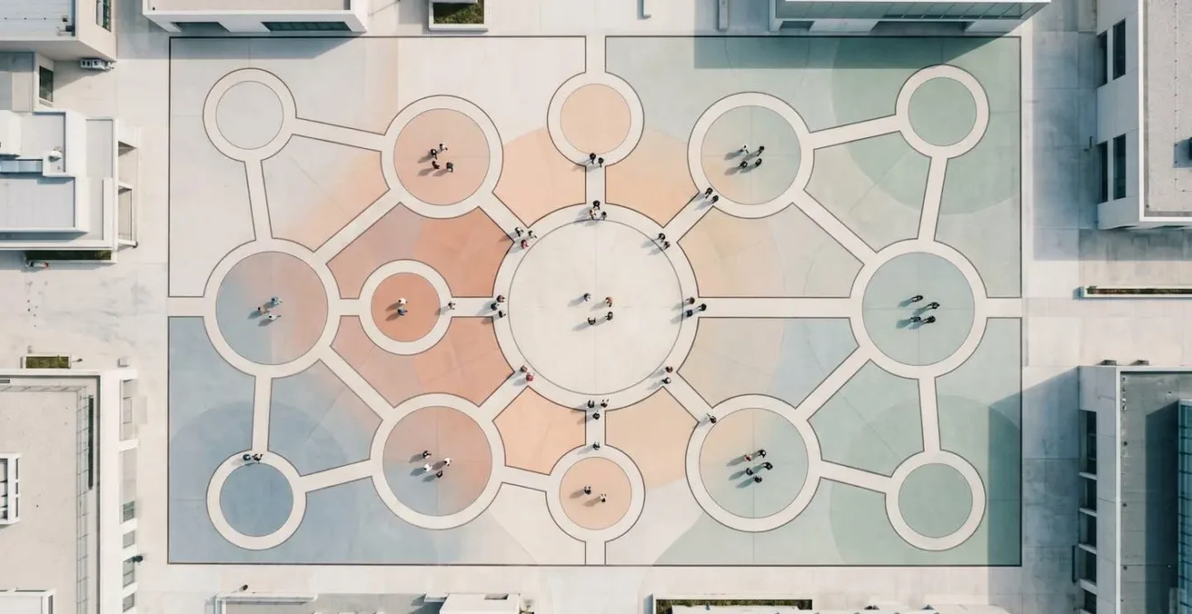 Conceptual overhead view of interconnected community nodes represented through environmental design, illustrating network epidemiology principles and transmission pathways without data visualization